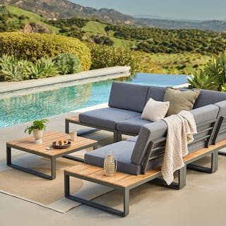 Poolside patio featuring the Kezia 100" Outdoor Corner Modular Sectional and Coffee Table