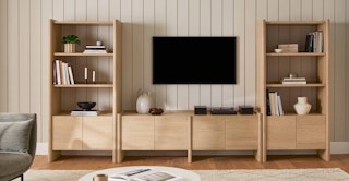 Bright living room featuring the Torme 72" Media Unit and 48" Bookcase, Tall in Smoked Oak
