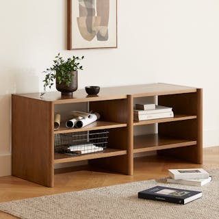Torme 57" Bookcase, Short in Smoked Oak, styled with books, plants, and art in an evening-lit room