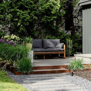 Garden patio featuring Laholm 70" Outdoor Loveseat in Dravite Black. Photo by @fernsliving