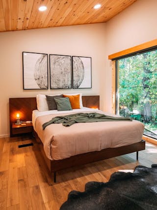 Nera Bed with Nightstands featured in a warm woodland cabin, Credit Hillside Amble