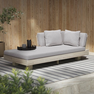 Shady outdoor space featuring the Lubek Outdoor Low Left Chaise Lounge in Beach Sand finish
