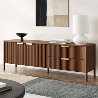 The Liv 74.5" Media Unit in Walnut features brass handles and fluted soft close doors and drawers.