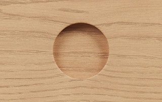 Detailed view of Adel Cabinet in White Oak finish, featuring its carved round drawer pull