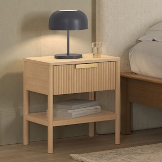 The Liv 1-Drawer Nightstand White Oak styled with a bedside lamp