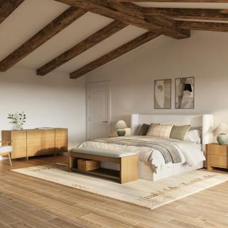 A cozy bedroom with a tufted bed, earthy tones, and soft natural light.