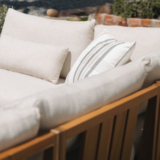 Close view of the Cove 102.75" Outdoor Armless Modular Sectional in Basket Beige. Photo by @sarah_norian