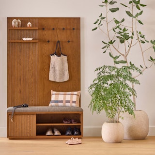 Kouva Bench and Wall panel set styled with a white shirt hanging from the hooks in a entryway of a home. 