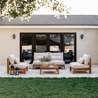 Shaded patio featuring Cove Armless Loveseat and two Armless Modules in Basket Beige, with Cove Coffee Table. Photo by @halfway_wholeistic