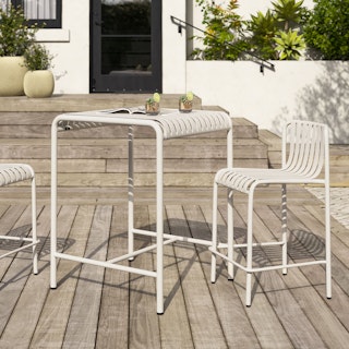 Sunny patio styled with the Sarek Outdoor Bar Table and Counter Chairs in Taupe