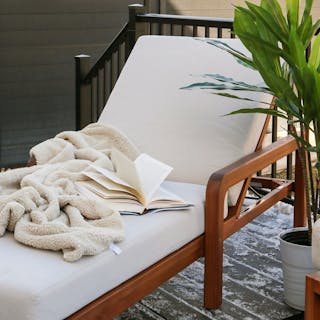 Styled image of the Laholm 78" Outdoor Chaise Lounge in Dravite Ivory